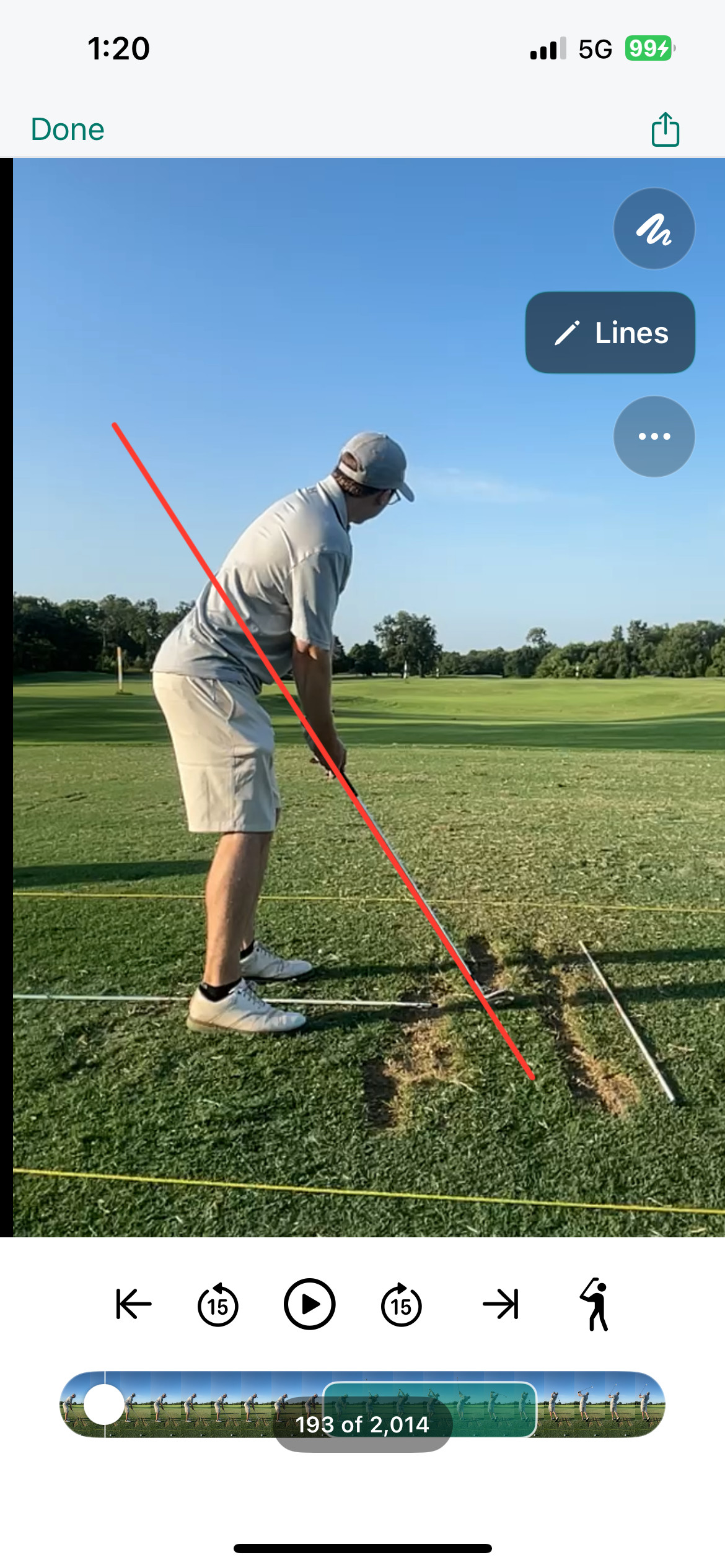 A golfer drawing a reference line over a swing video in the SwingGrabber iPhone app